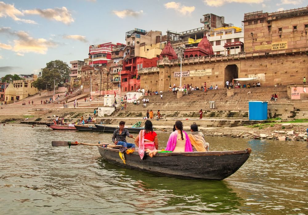 A wooden boat on the Ganges in front of the Varanasi ghats