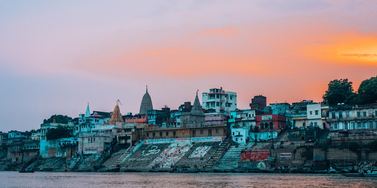 The riverfront ghats at Varanasi at dusk, seen from the water