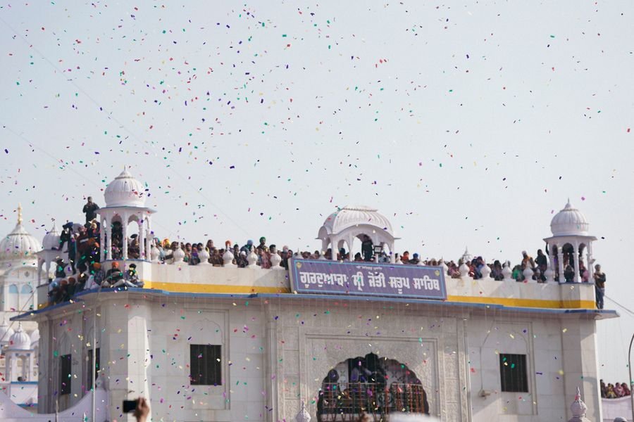 The gateway of a gurdwara with birds overhead