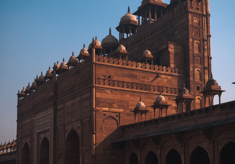 A red sandstone Mughal gateway rising above its courtyard