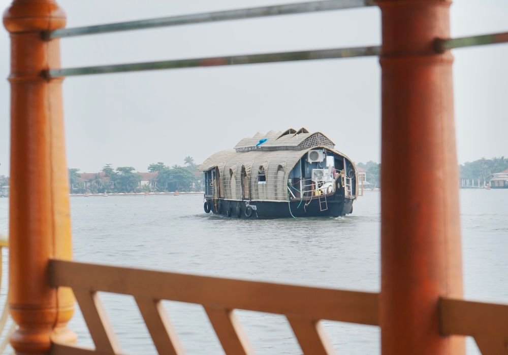 A houseboat seen from the shaded deck of another