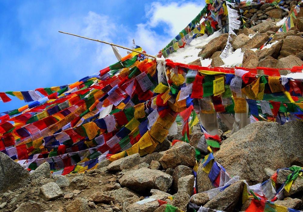 Buddhist prayer flags strung across rocks