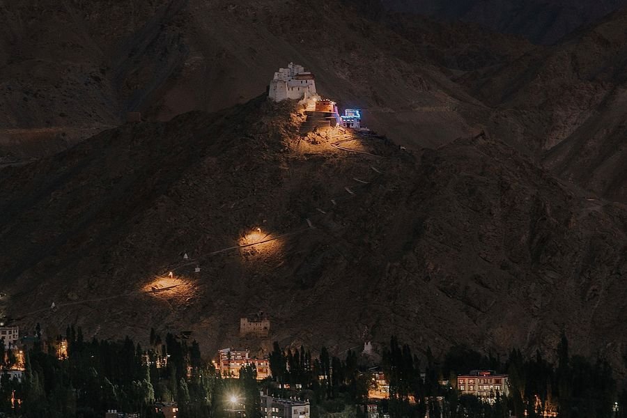 A palace above the town at dusk