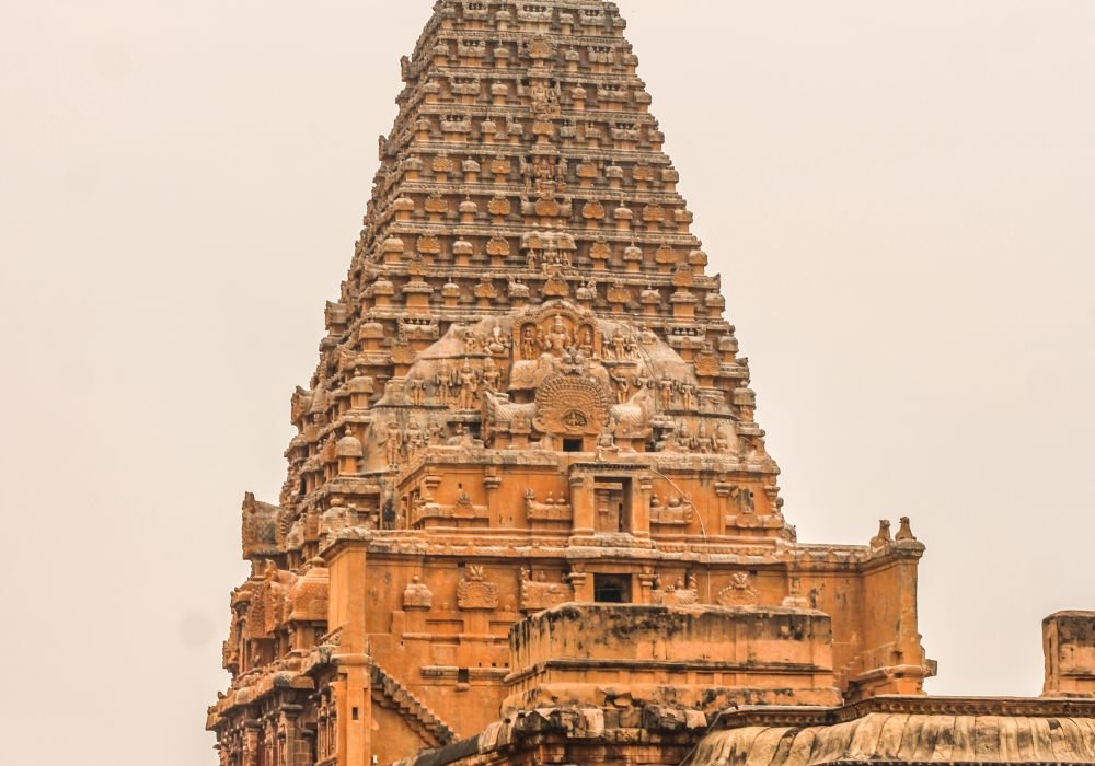 A tall granite temple tower in the morning light